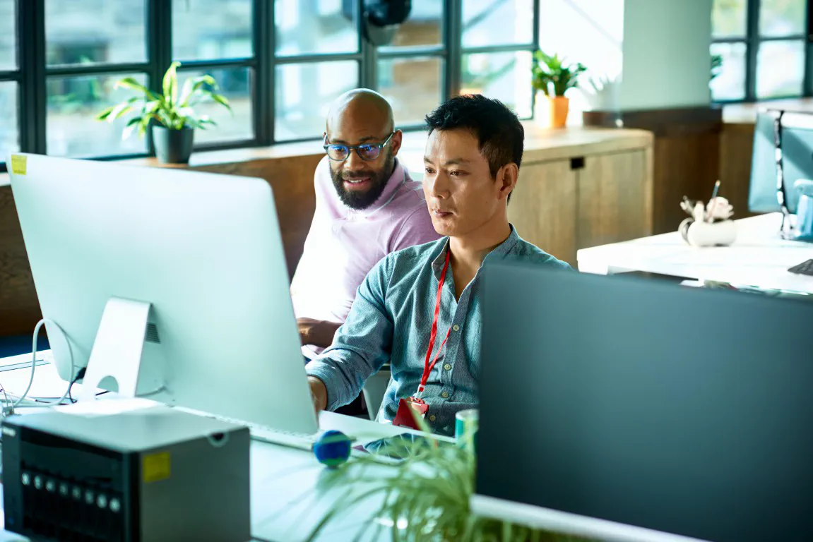 Coworkers at a computer desk